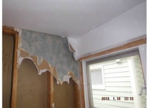 I'm not quite sure what wall this is, but I believe it's the one that came down in the kitchen.  Look what was under the wallboard.  Glad they documented this wallpaper for me.