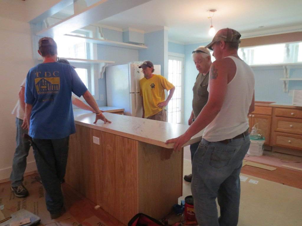 Here's a longer view as the guys installed the island between the dining area and kitchen.  This used to be a wall.  