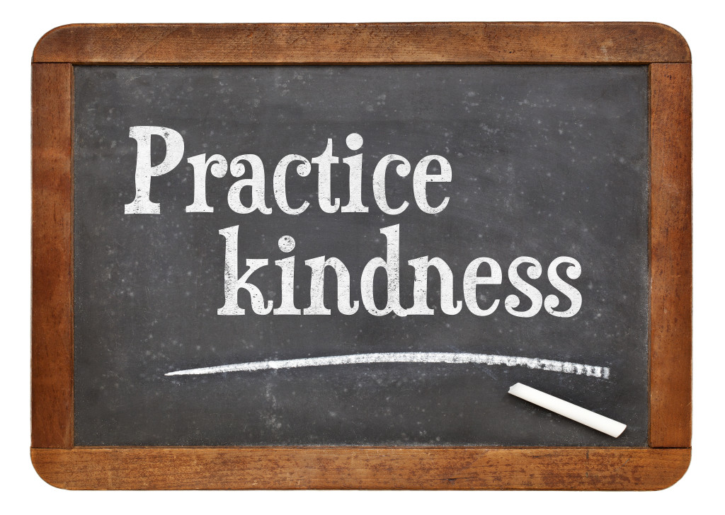 Practice kindness - inspirational advice on a vintage slate blackboard